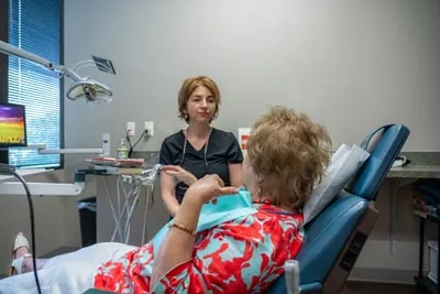 Brilliant Smiles dental patient talking with Agnes about same-day dental crowns