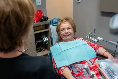 patient smiling during her dental implants consultation at Brilliant Smiles in Austin, TX