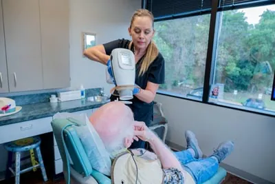Annette from Brilliant Smiles taking x-rays of a dental patient