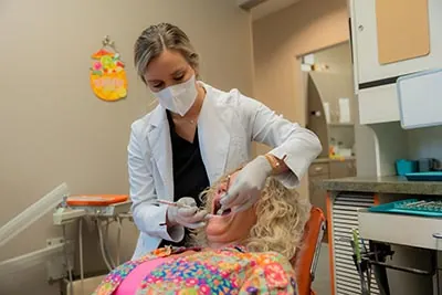Dr. Tianne Voorhees performing an emergency dentistry procedure on a patient